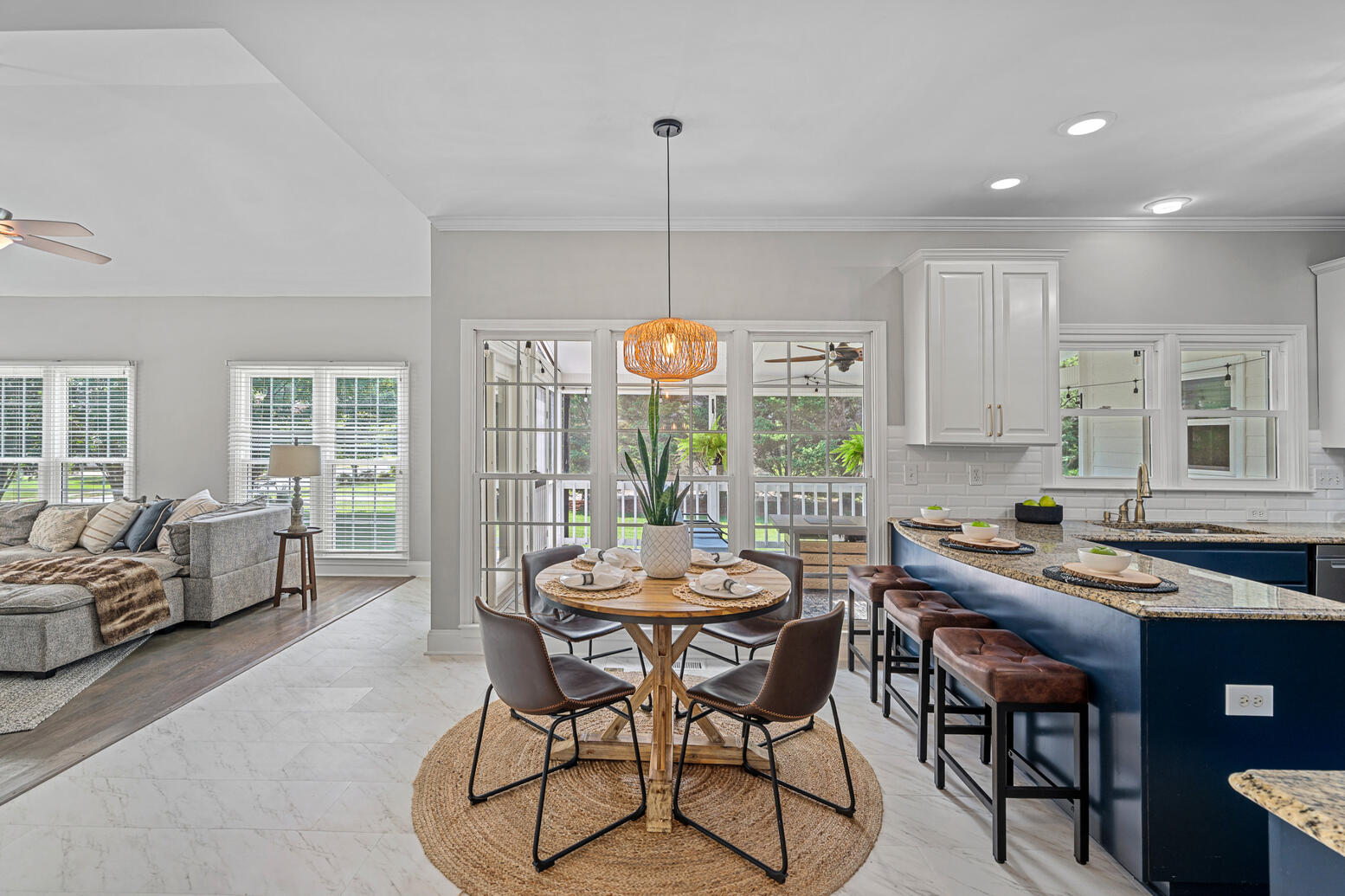 Bright breakfast area in Birkdale Huntersville home with views of private yard and screened patio.