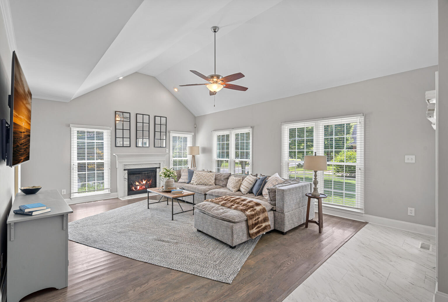 Open concept family room in Birkdale Huntersville home featuring fireplace and modern design.