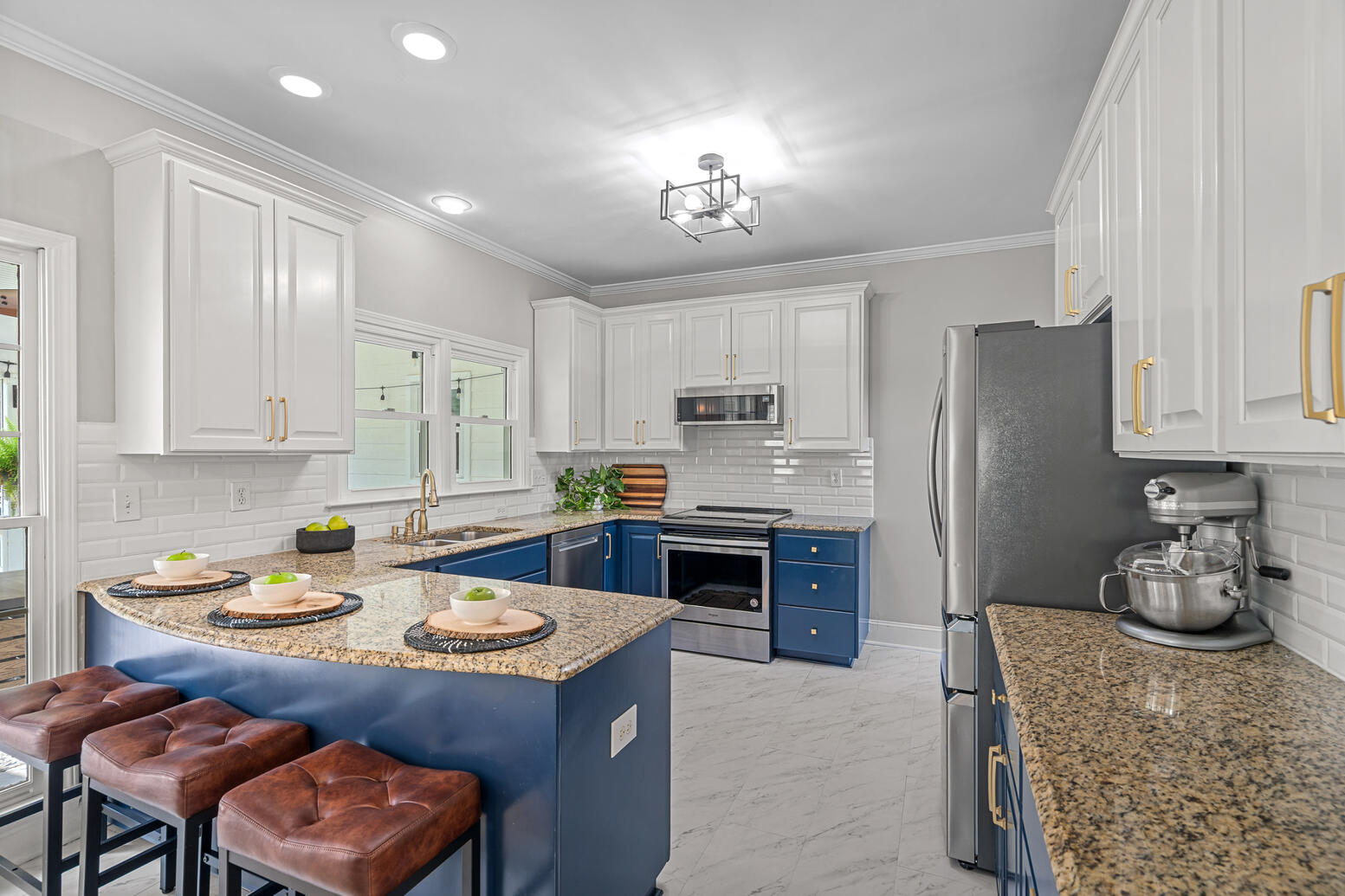 Modern kitchen with granite countertops and stainless steel appliances at 8948 Devonshire Drive Huntersville NC.