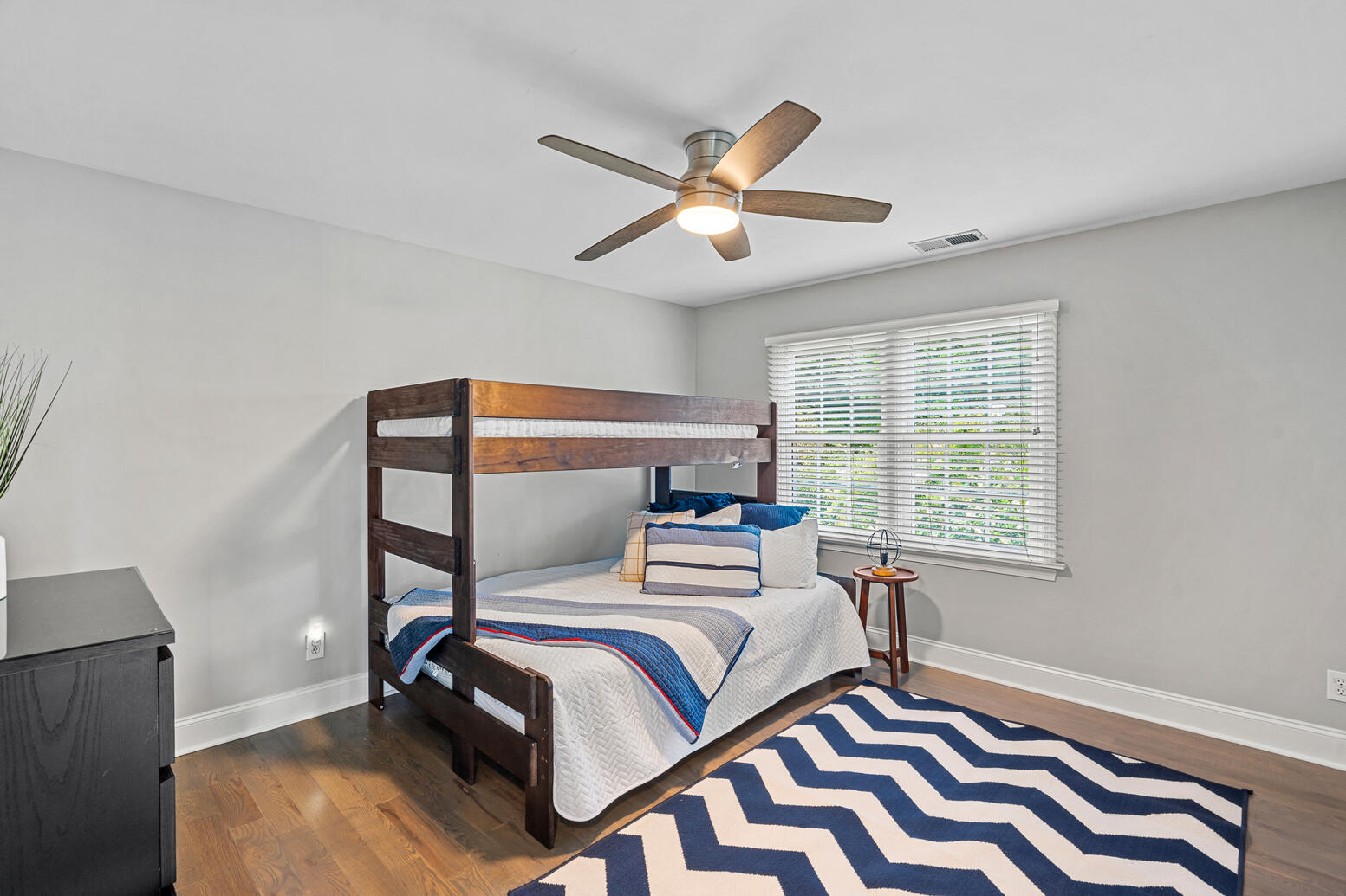 Bright third bedroom in Huntersville NC home for sale with large windows and closet space.