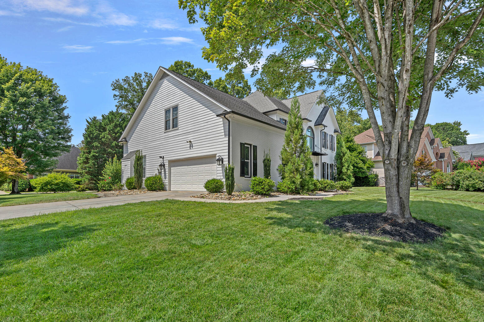 Huntersville NC home for sale with tree lined backyard and landscaped lot in Birkdale community.