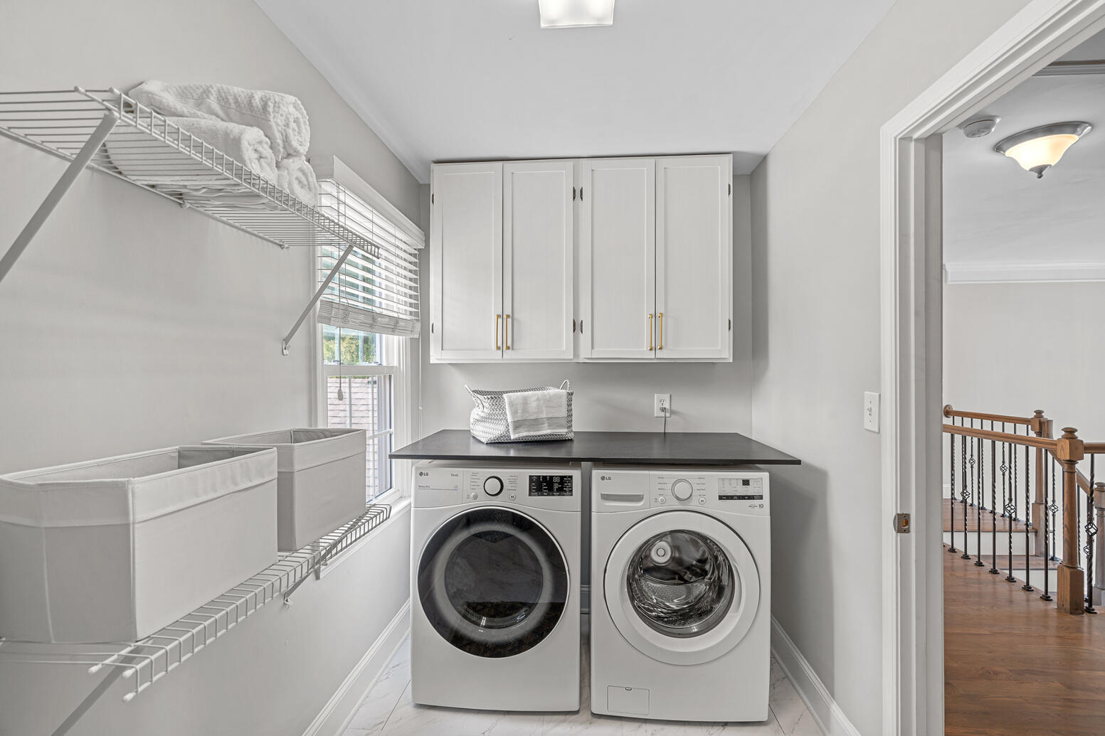 Large upstairs laundry room with built‑in cabinets at 8948 Devonshire Drive Huntersville NC.