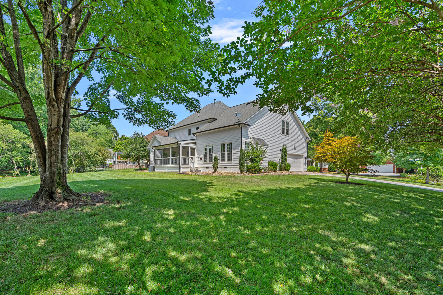 Private backyard at 8948 Devonshire Drive Huntersville NC with patio and mature landscaping.